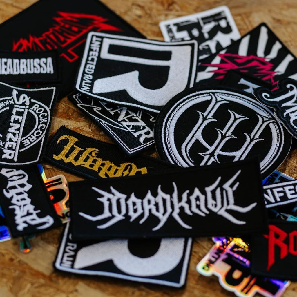 Collection of custom embroidered metal band patches and merchandise accessories