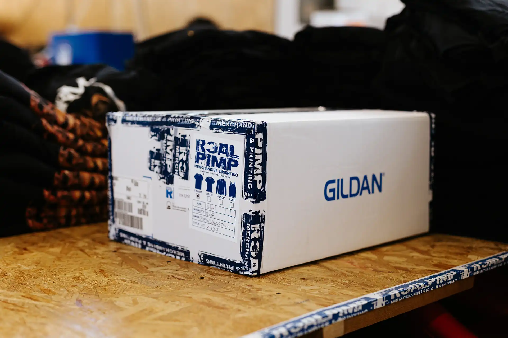 Gildan merchandise box secured with Real Pimp custom branded navy packing tape