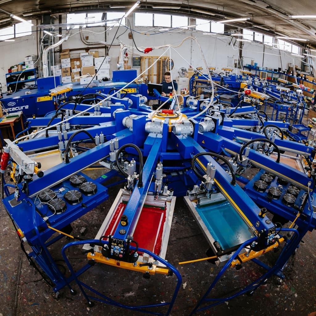 Industrial screen printing facility with carousel machines for custom band merchandise production