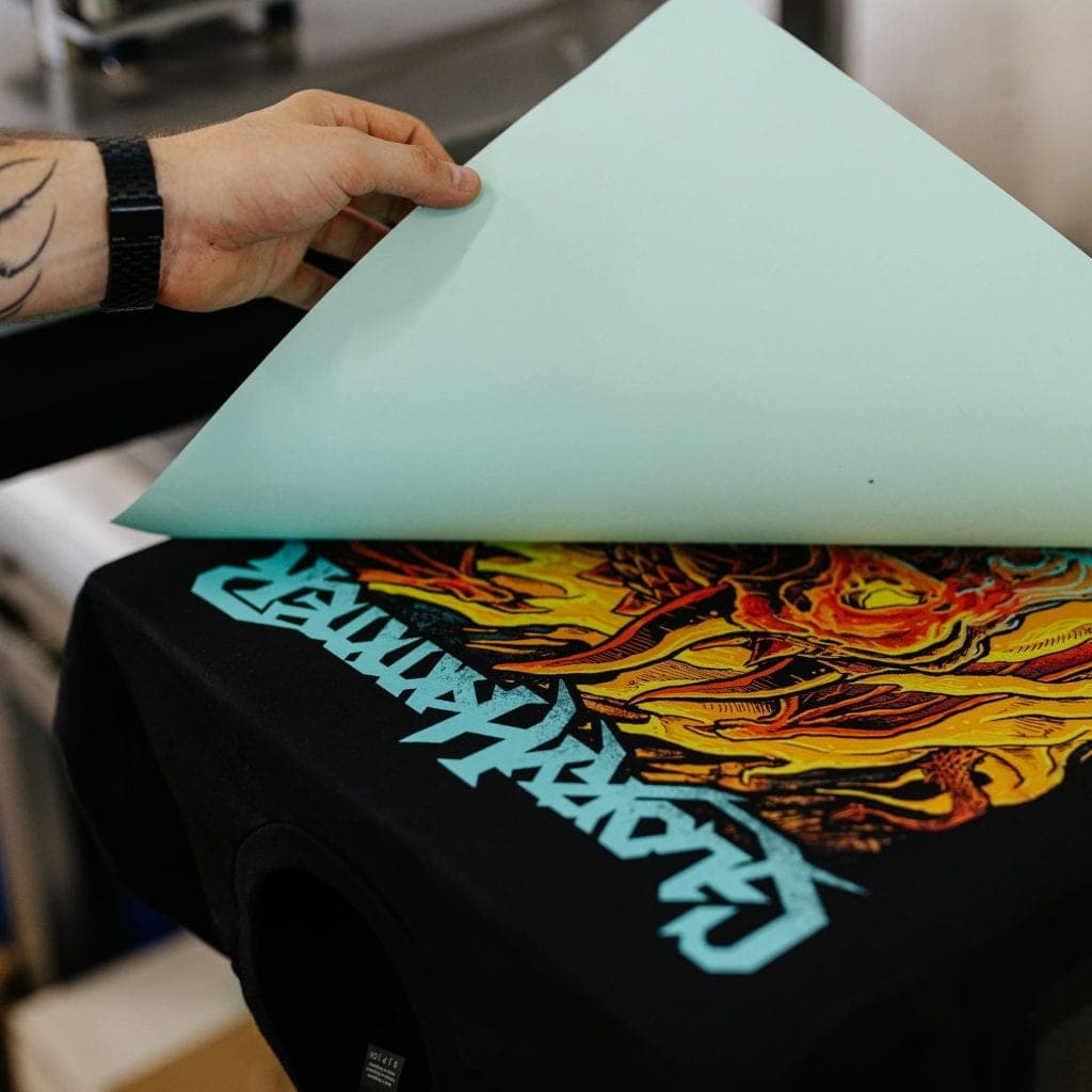 Heat transfer printing equipment creating detailed colorful designs on band merchandise