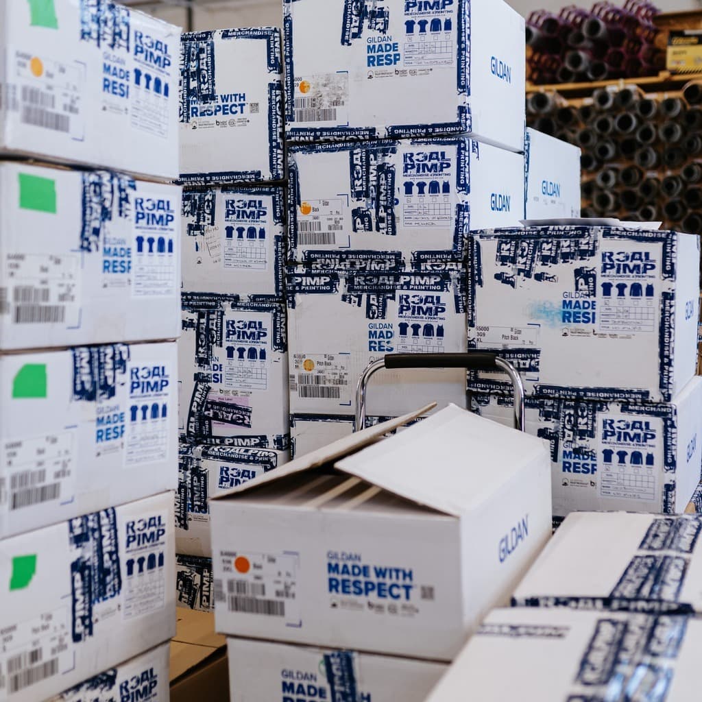 Branded Real Pimp shipping boxes ready for band tour merchandise delivery across Europe