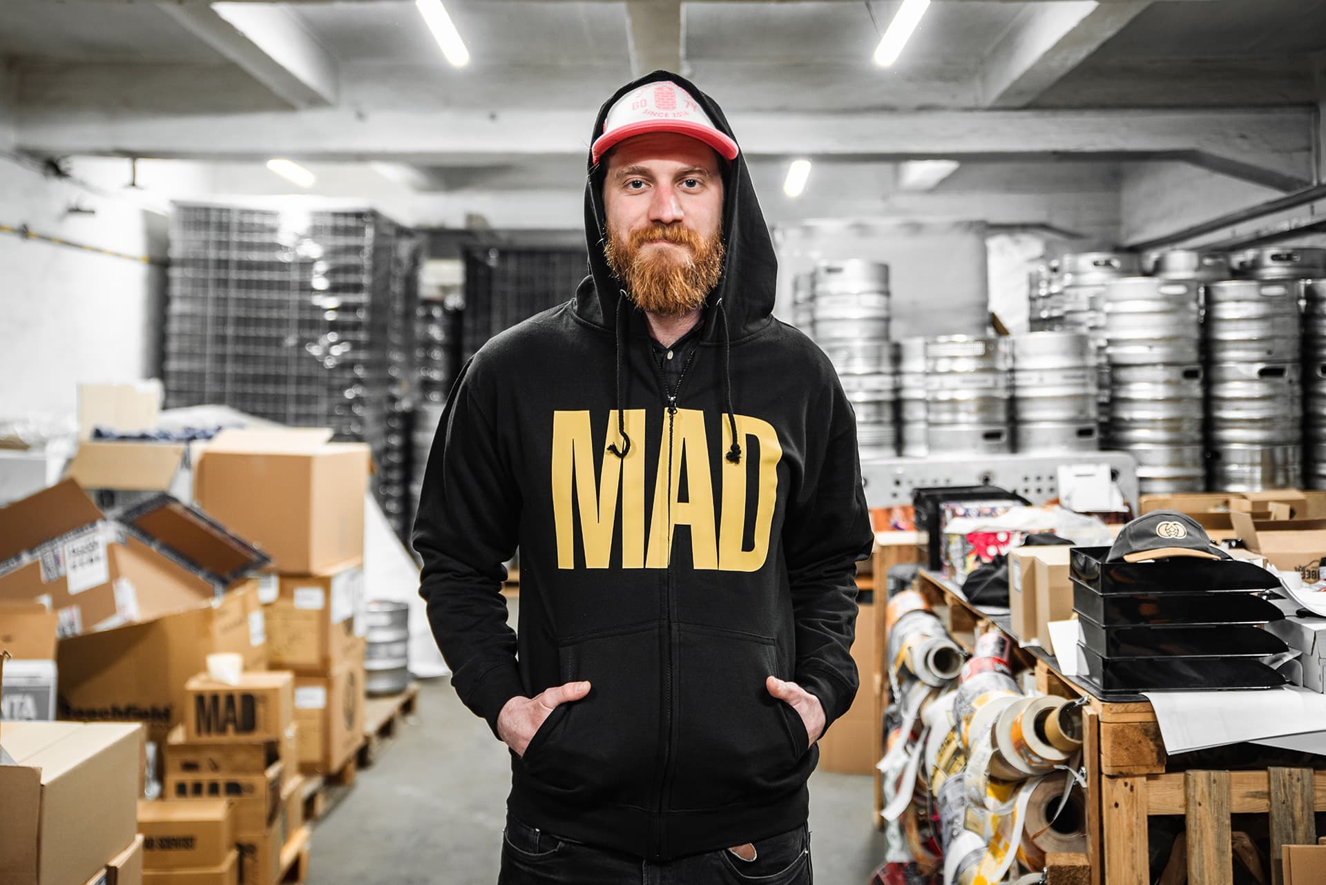 MAD Scientist brewery branded hoodie merchandise worn in industrial warehouse setting