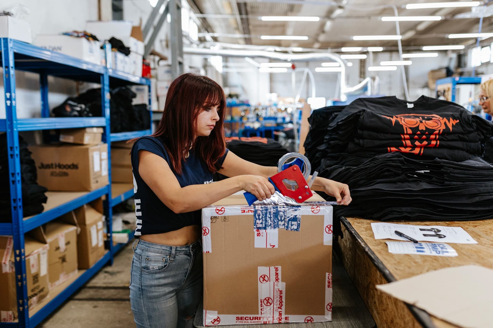 Packing custom festival merchandise for European music festival shipment at Real Pimp
