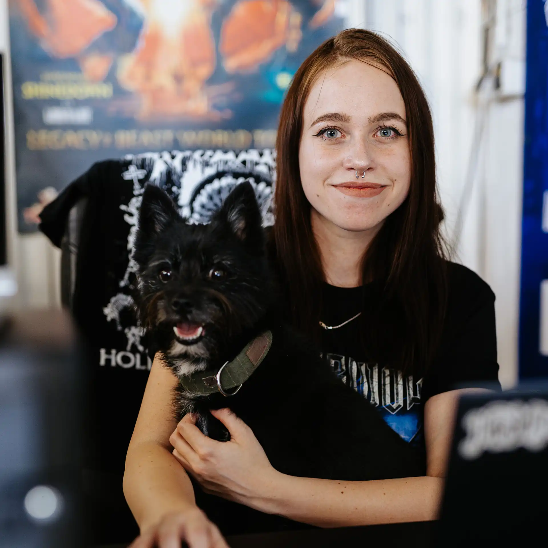Real Pimp team member in band merchandise production office with festival backdrop