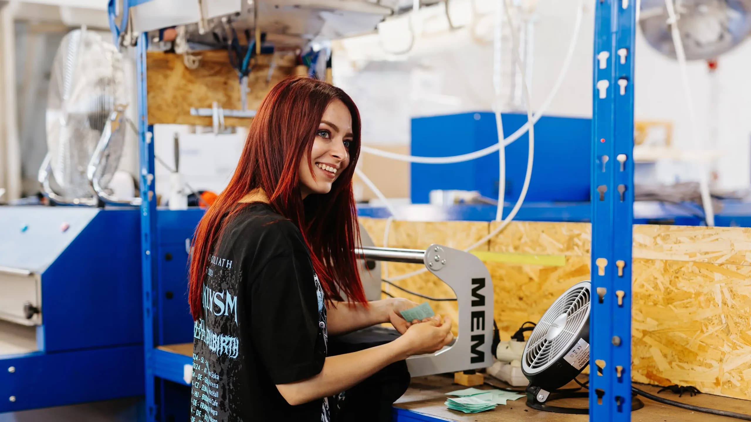 Professional label application using MEMI heat press machine for custom band merchandise