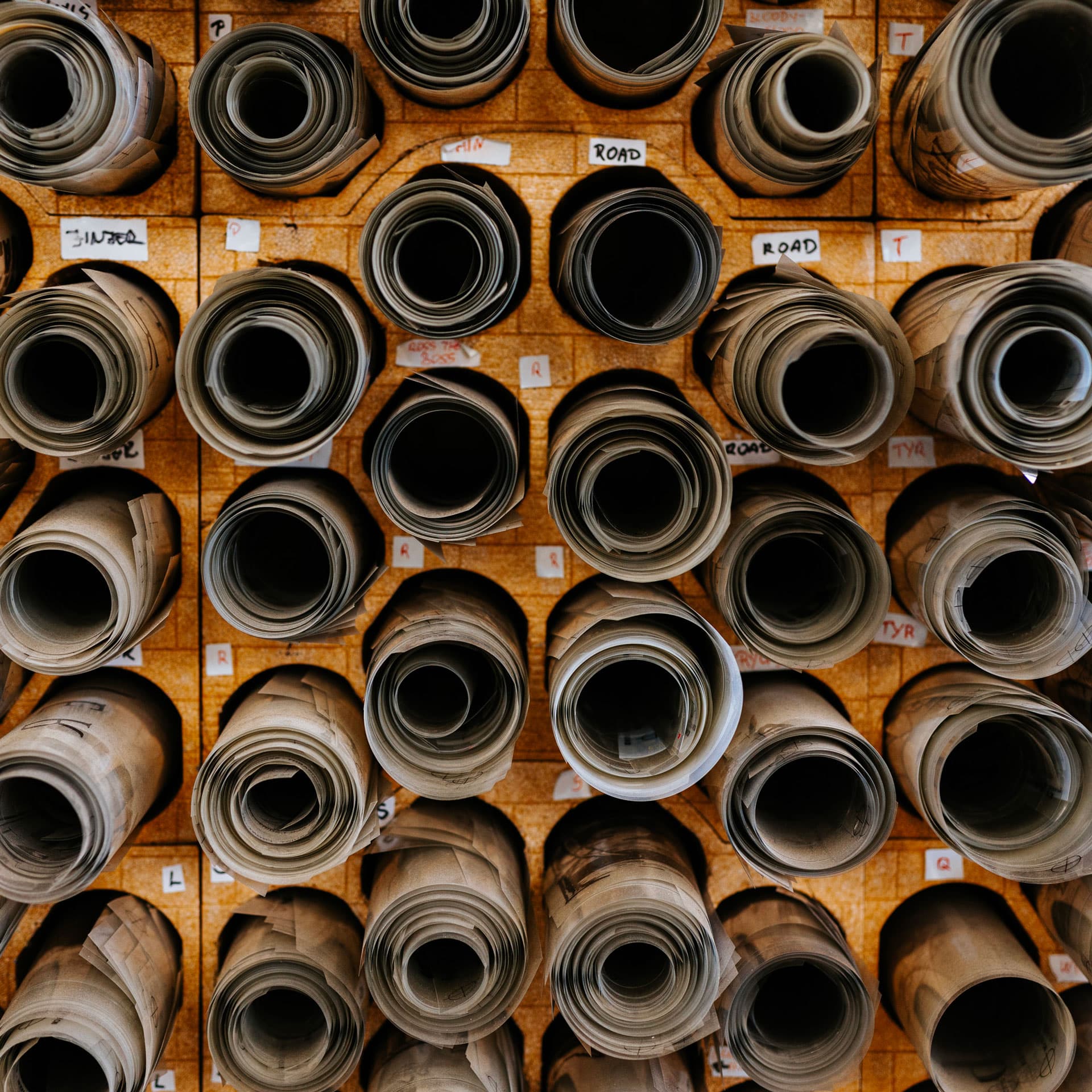 Organized storage of rolled screen printing screens in Real Pimp production workshop